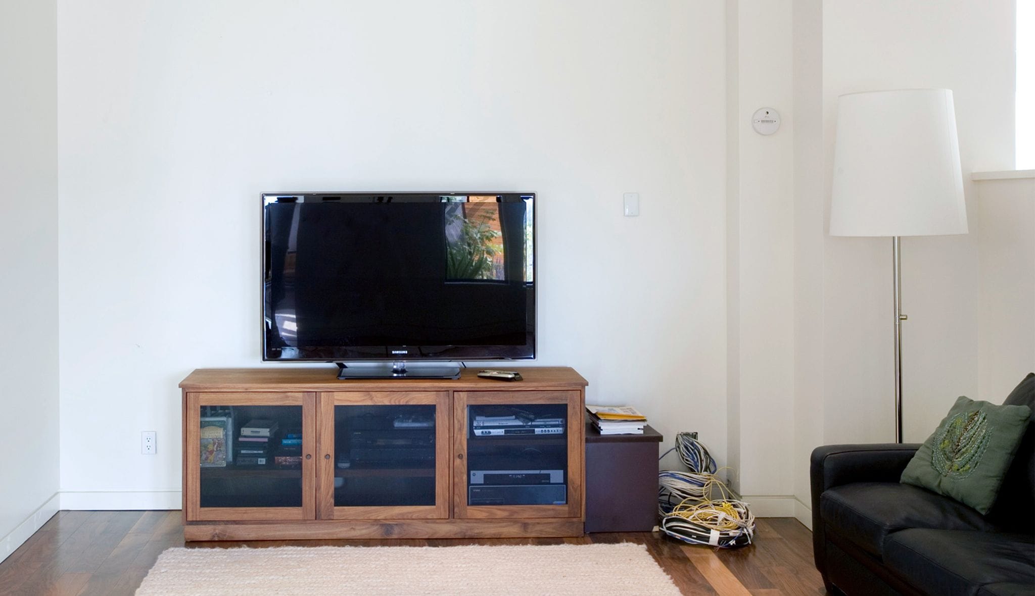 Prior to entertainment center added area with no media storage and outdated furniture with California Closets designs