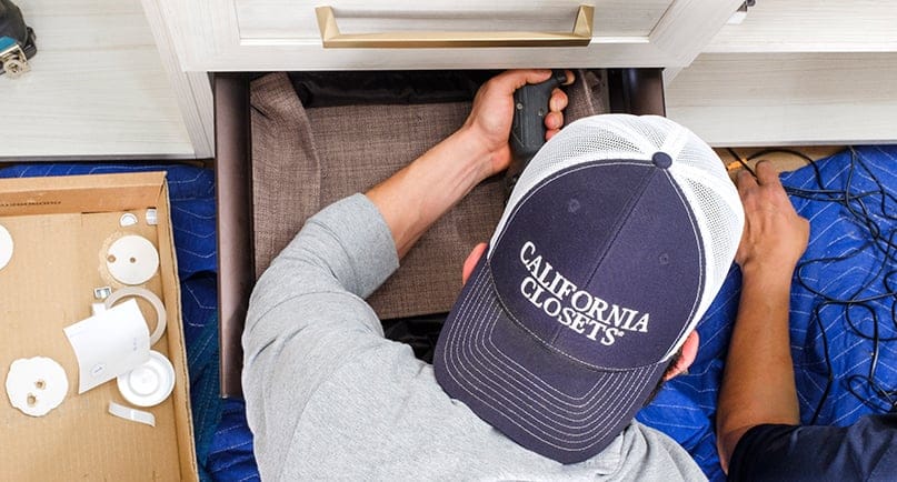 Custom storage solution being installed by professional technician trained by California Closets