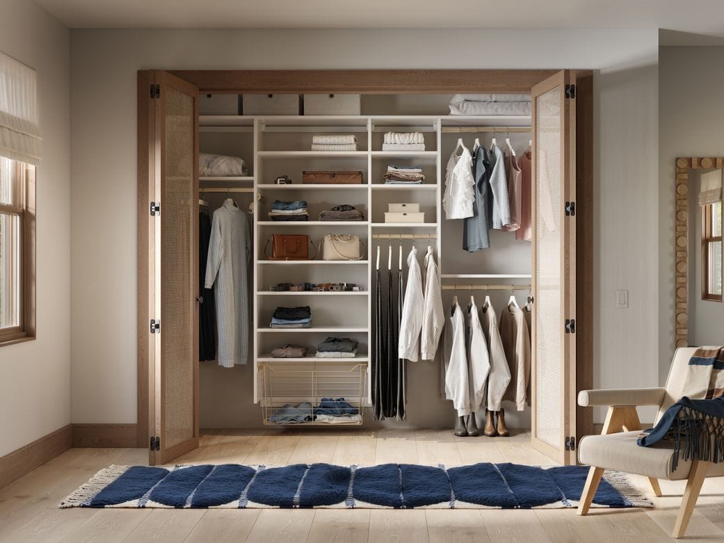 Reach in customized closet with extra open shelves short and long hang wardrobe design by California Closets